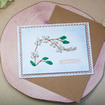 Елегантна ръчно бродирана картичка с клонче бели цветя