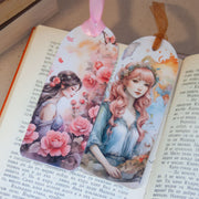 Комплект от два книгоразделителя с момичета и цветя, поставени върху отворена книга.